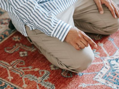Close up of hands in prayer position during meditation