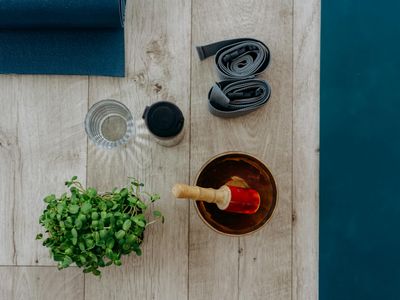 Yoga blocks and strap on a wooden floor texture